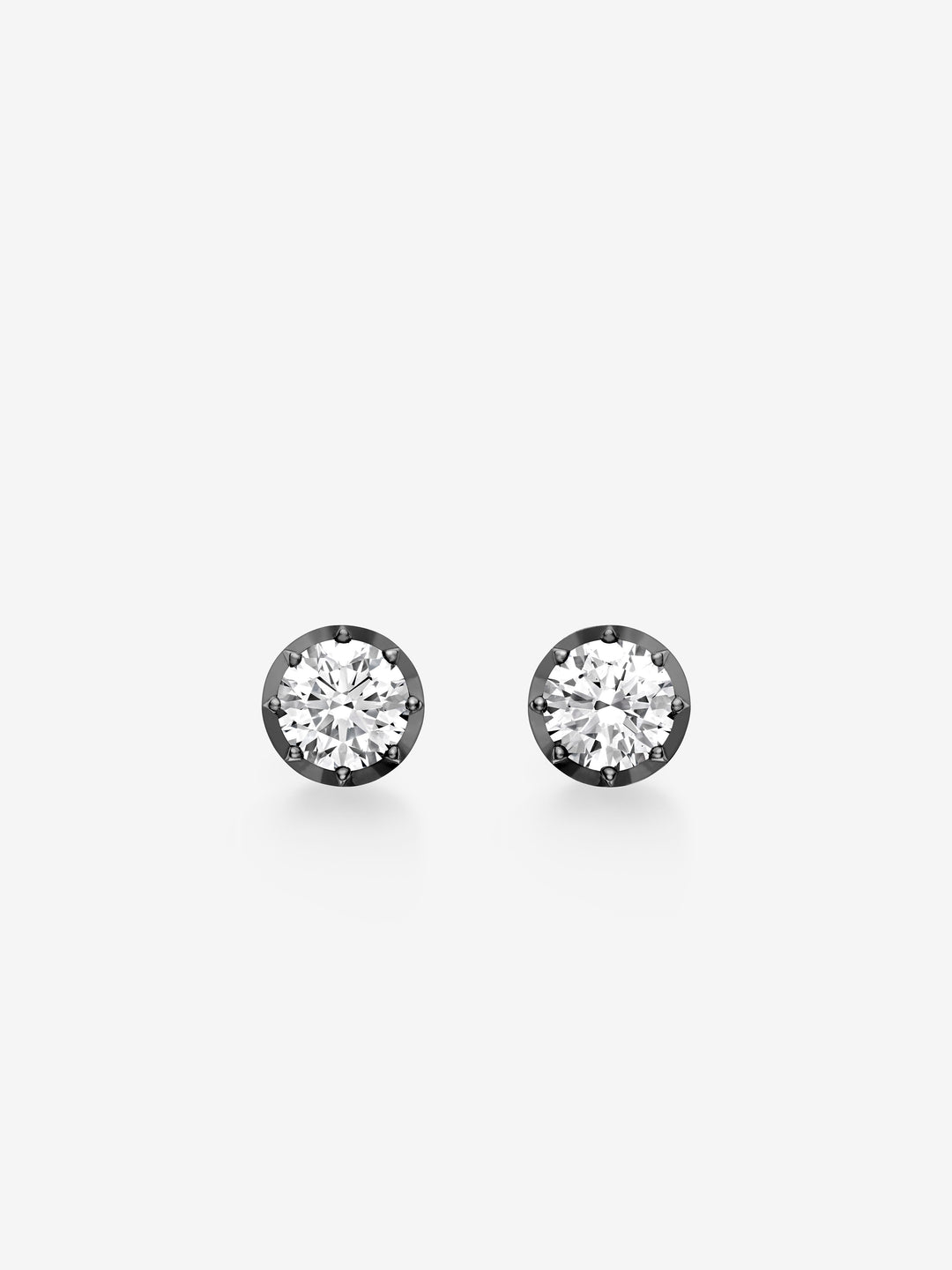 Pair of 2ct diamond stud earrings set in blackened gold, showcasing classic craftsmanship with a contemporary, antique-inspired design.  View 1