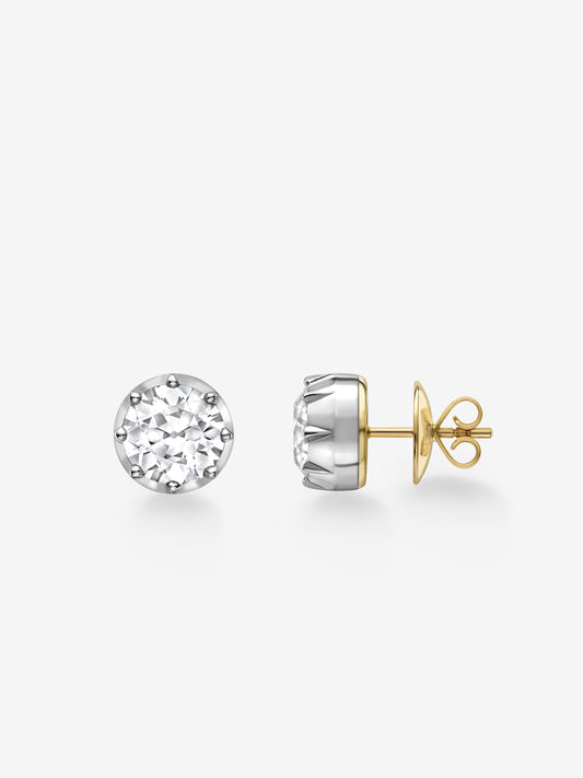 Pair of round-cut diamond stud earrings set in white gold with yellow gold butterfly backs, showcasing a blend of antique-inspired and contemporary craftsmanship. View 2