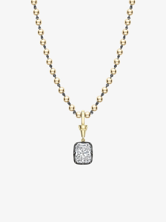 Cushion-cut diamond pendant set in blackened gold, hanging from a delicate yellow gold ball chain necklace, showcasing handcrafted contemporary vintage-inspired design. View 2