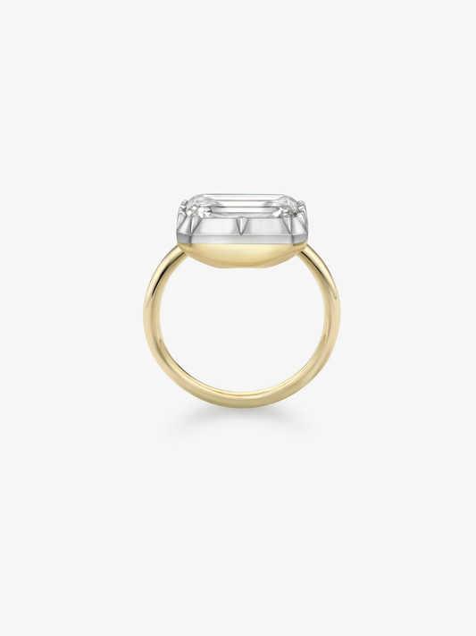 Minimalist two-tone ring featuring a horizontal emerald cut diamond set in a traditional yellow gold band with a white gold bezel, showcasing timeless craftsmanship. View 3