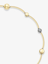 Delicate yellow gold necklace featuring a blend of smooth gold spheres and a pavé diamond sphere, showcasing timeless craftsmanship with contemporary elegance.