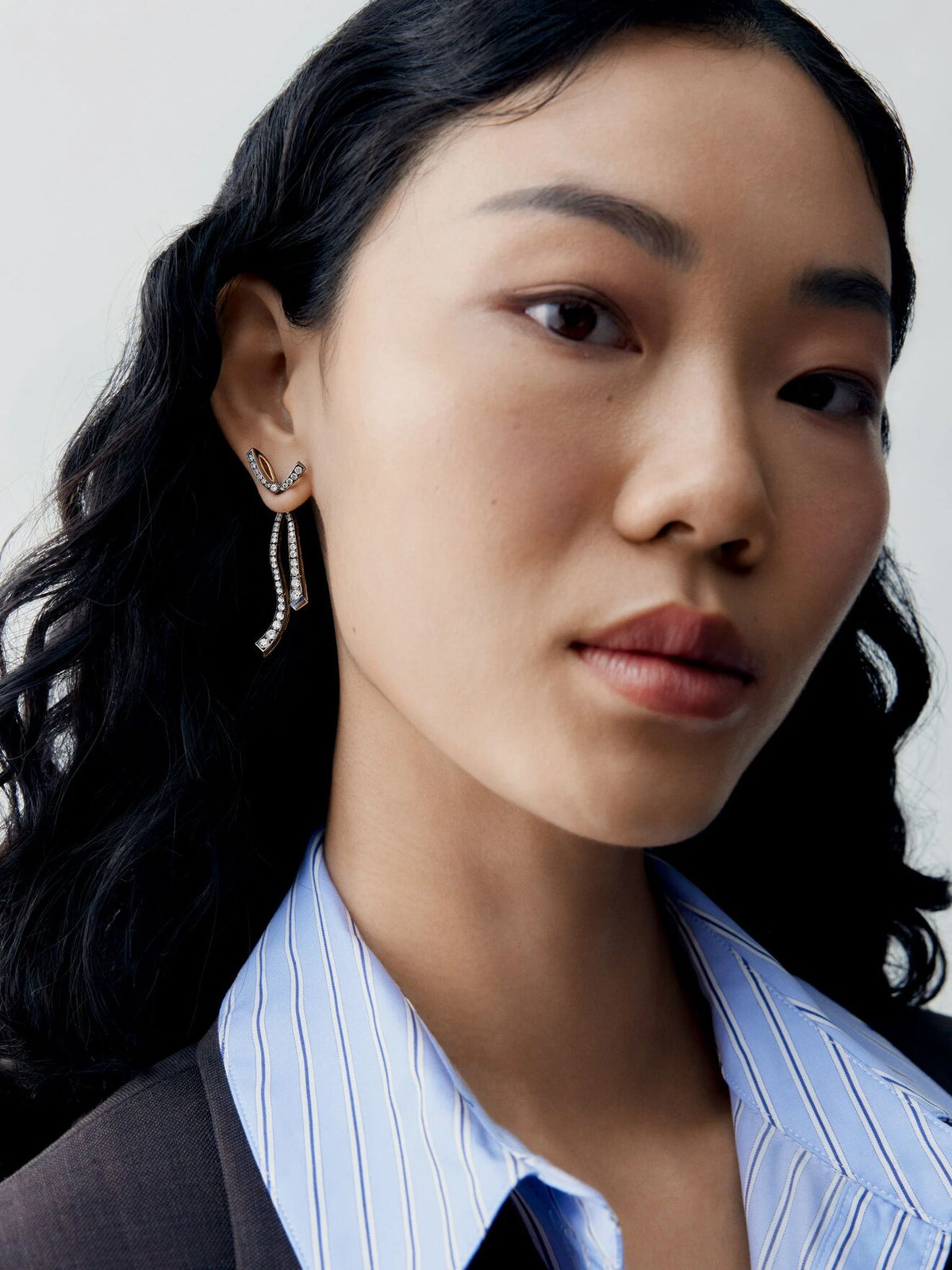 Jessica McCormack diamond bow and ribbon drop earring worn on a model, featuring delicate articulated strands and a refined contemporary design View 5