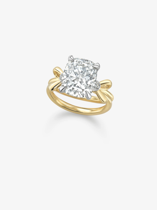 Cushion cut diamond ring with a 5.11ct centre stone, sculptural yellow gold bands, white gold claw settings and delicate side diamonds View 2