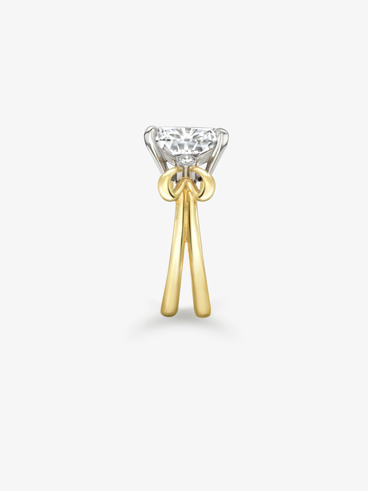 Cushion cut diamond ring with a sculptural bow setting, contrasting white and yellow gold details, showcasing Jessica McCormack craftsmanship View 3