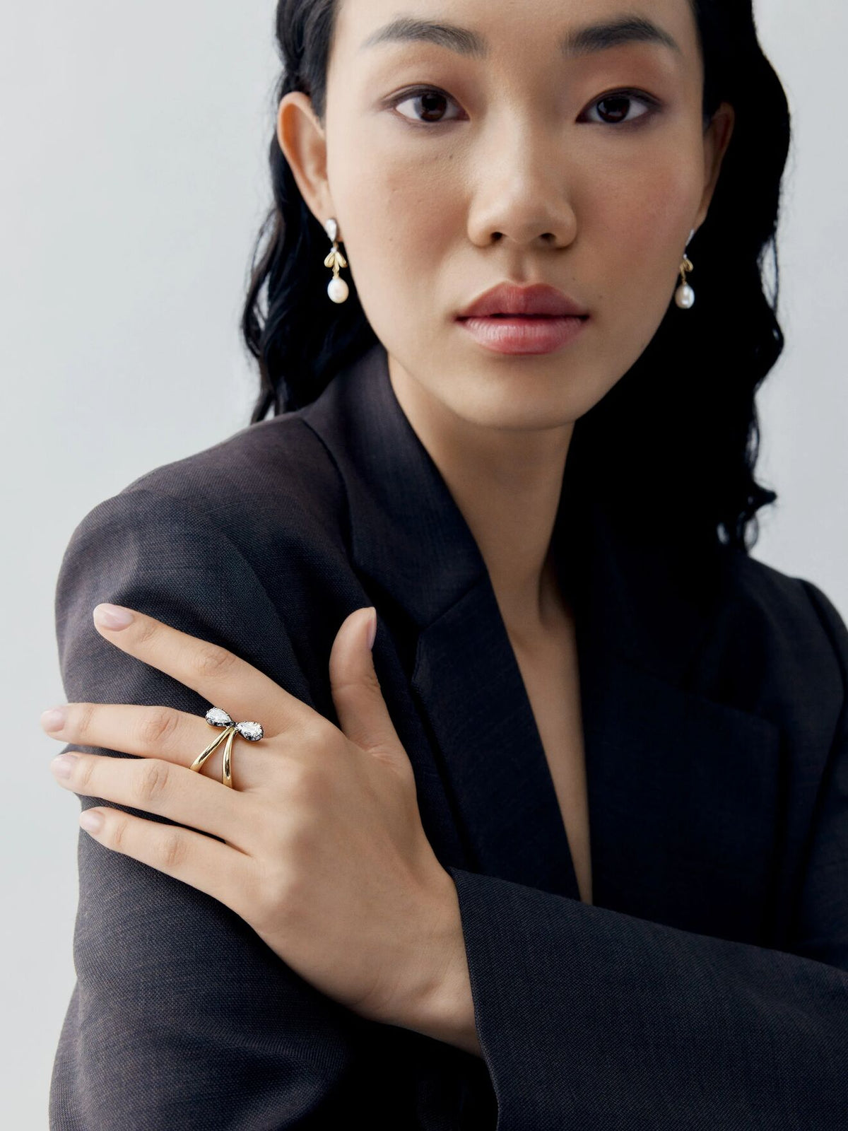 Jessica McCormack pear-shaped diamond ring in blackened gold worn on a model's hand, showcasing antique-inspired craftsmanship and contemporary style View 3