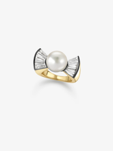 Diamond and pearl ring with a round white pearl set between fan shaped diamond bows on a polished yellow gold band