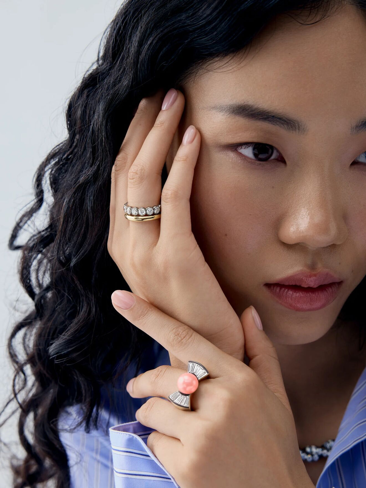 Model wearing a bow-inspired diamond and conch pearl ring, featuring a soft pink pearl and sculptural diamond detailing. View 3