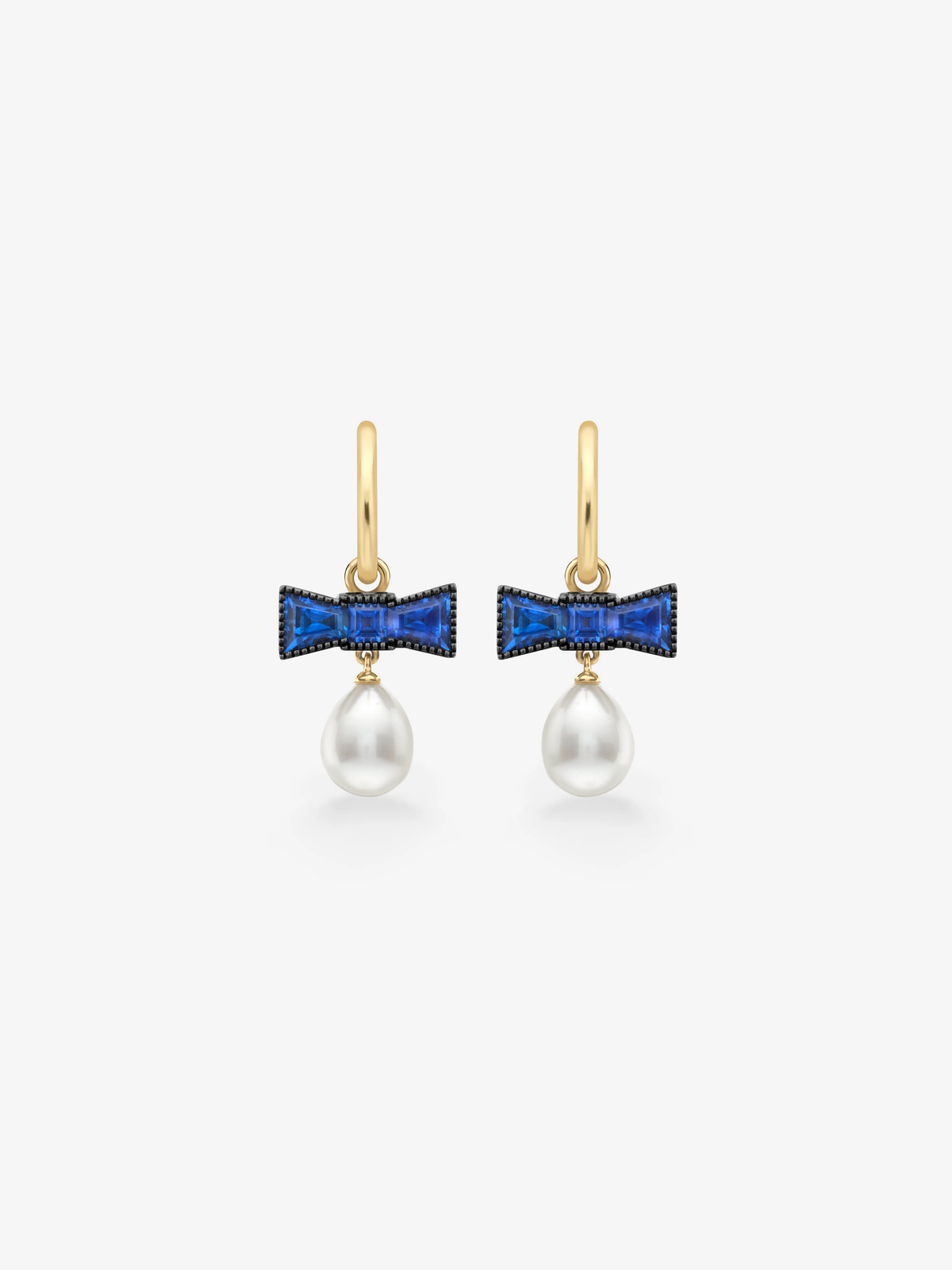 Jessica McCormack sapphire bow earrings with vivid blue stones and lustrous pearl drops on gold ear wires View 1