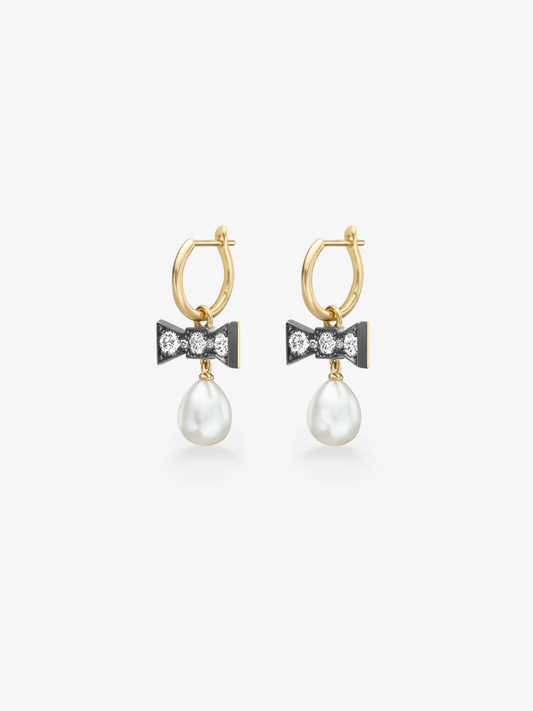 Gold hoop earrings with blackened bow details set with round brilliant cut diamonds and dangling white pearls in a contemporary gypset design View 2