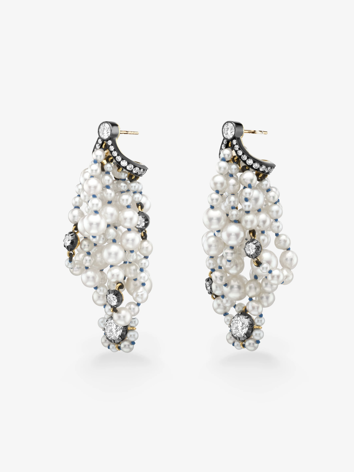 Pair of pearl and diamond drop earrings with clustered white pearls, round diamonds and blackened gold bow details against a white background View 2