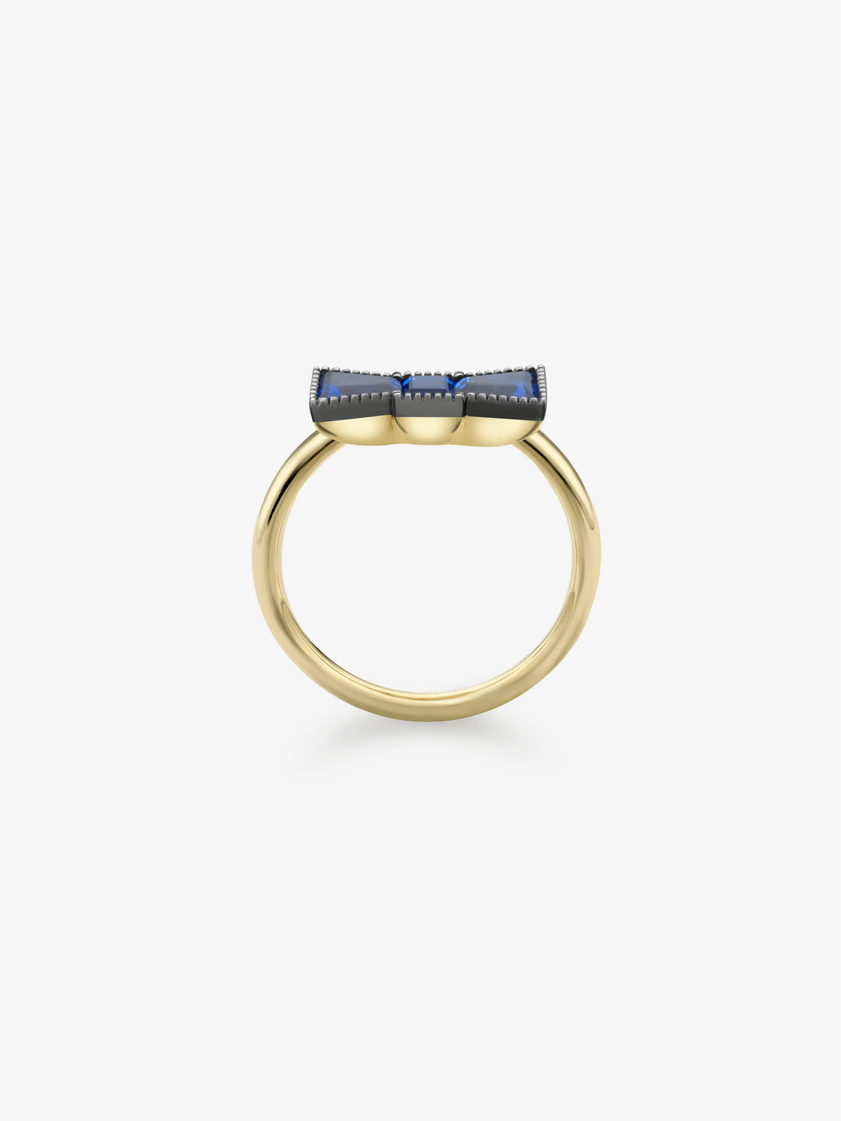 Yellow gold ring featuring deep blue sapphires in a sculptural bow-inspired setting, shown from the side. View 4