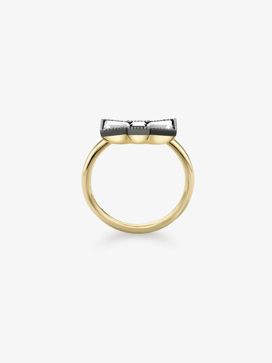 Blackened gold diamond ring with a polished yellow gold band and raised bow-inspired setting, shown in profile. View 4