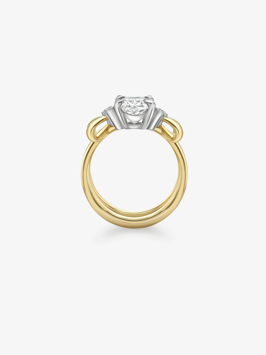 Oval diamond ring with a yellow gold band and contrasting white gold bow inspired setting showcasing distinctive craftsmanship in a contemporary design View 4