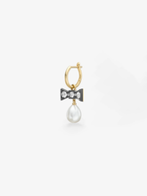 Jessica McCormack single hoop earring with a yellow gold hoop diamond set blackened bow motif and a hanging white pearl