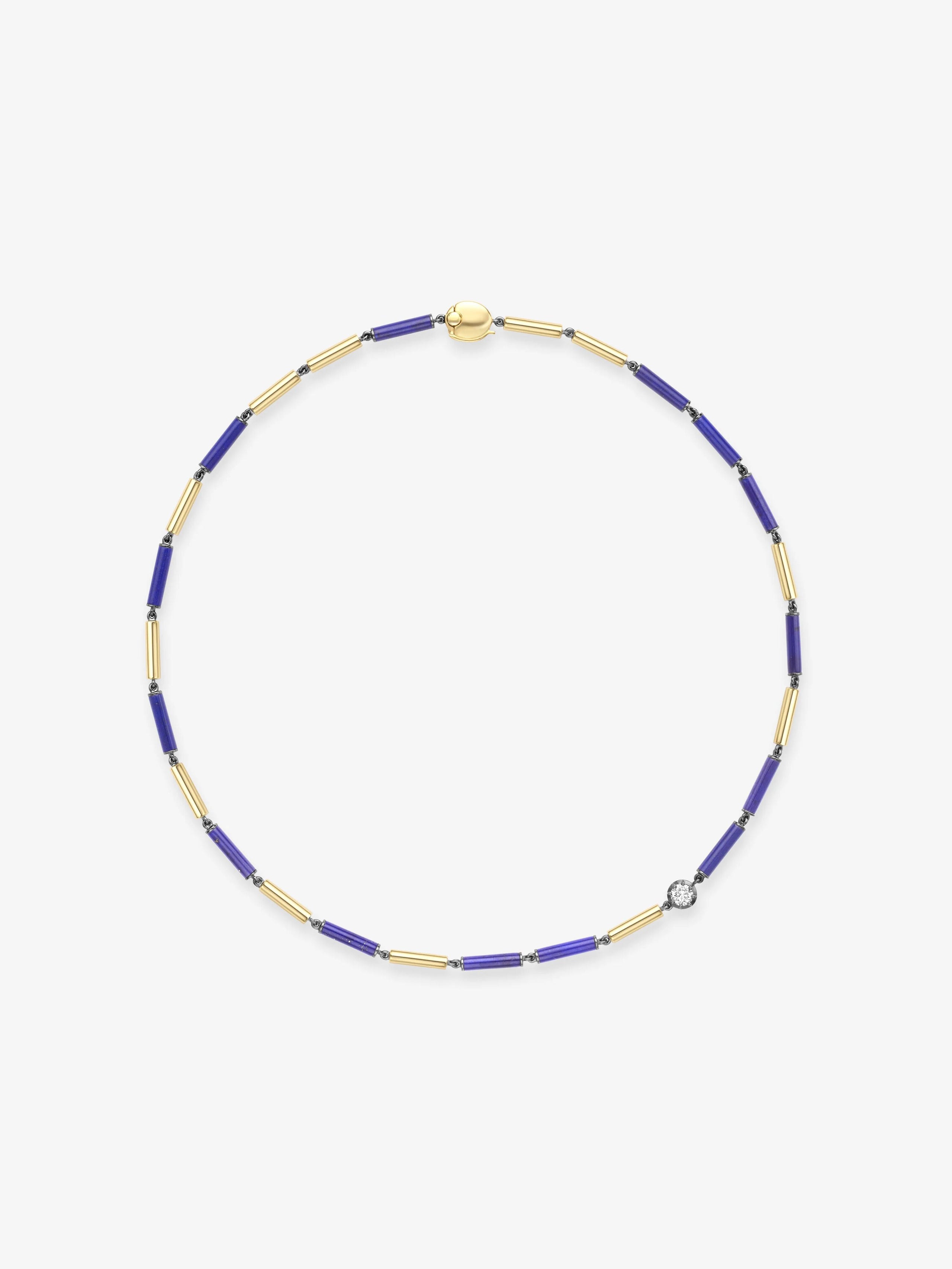 Delicate necklace featuring elongated blue lapis beads and gold links, accented with a single diamond, showcasing artisanal craftsmanship and contemporary design. View 1