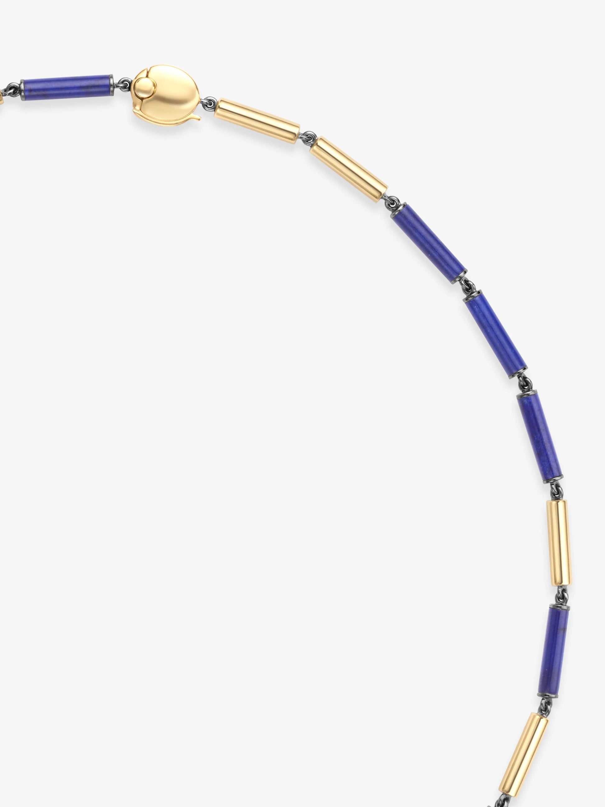 Segmented necklace featuring alternating gold and deep blue lapis cylinder beads, connected by dark metal links, showcasing a blend of antique and contemporary craftsmanship. View 3