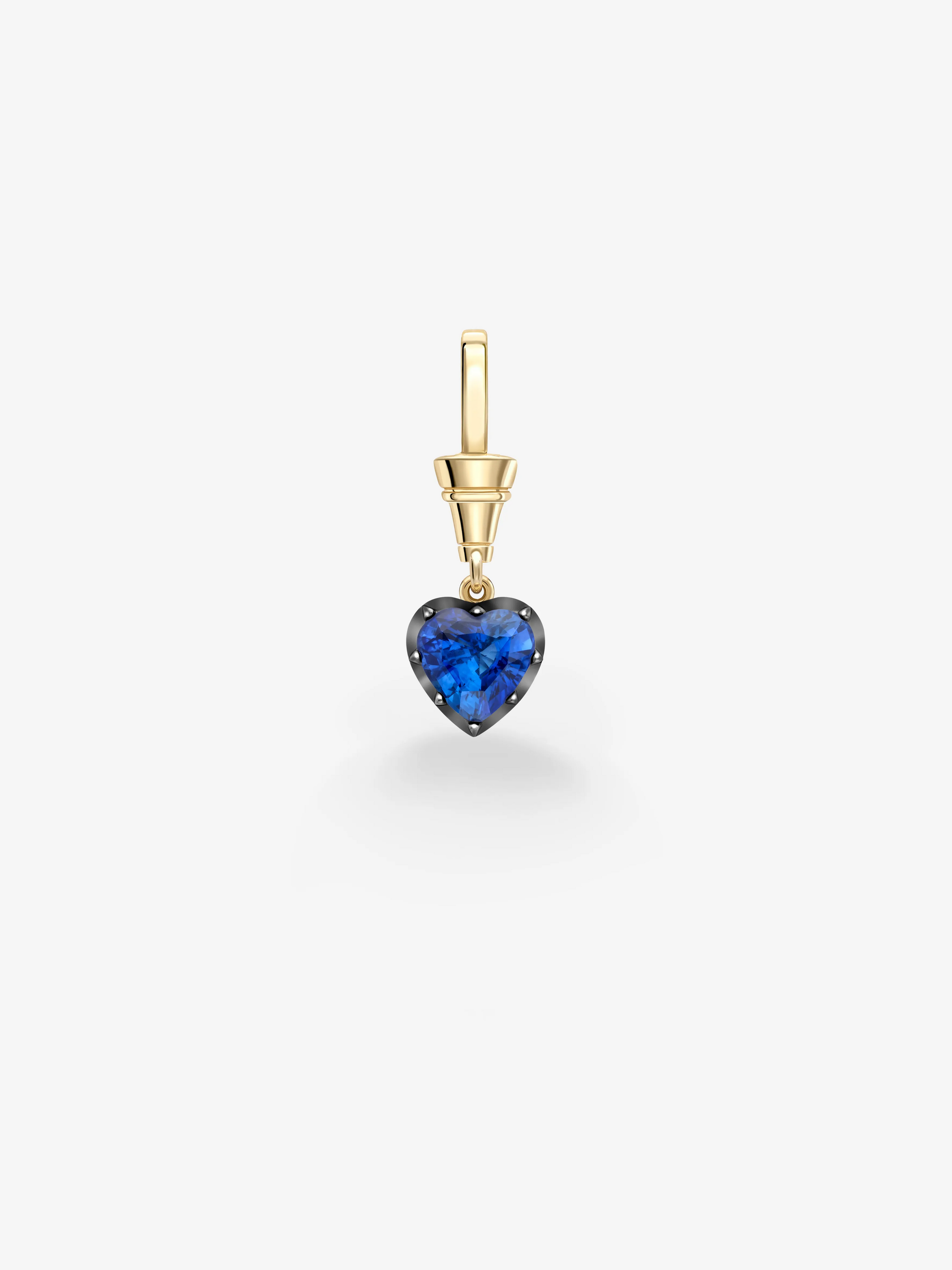 Heart-shaped deep blue sapphire pendant set in traditional gold and blackened metal, showcasing handcrafted antique-inspired contemporary design. View 1