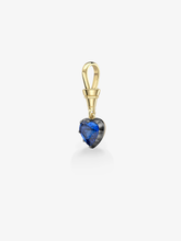 Heart-shaped vibrant blue sapphire pendant set in blackened metal with a polished yellow gold bail, blending antique craftsmanship with contemporary design.