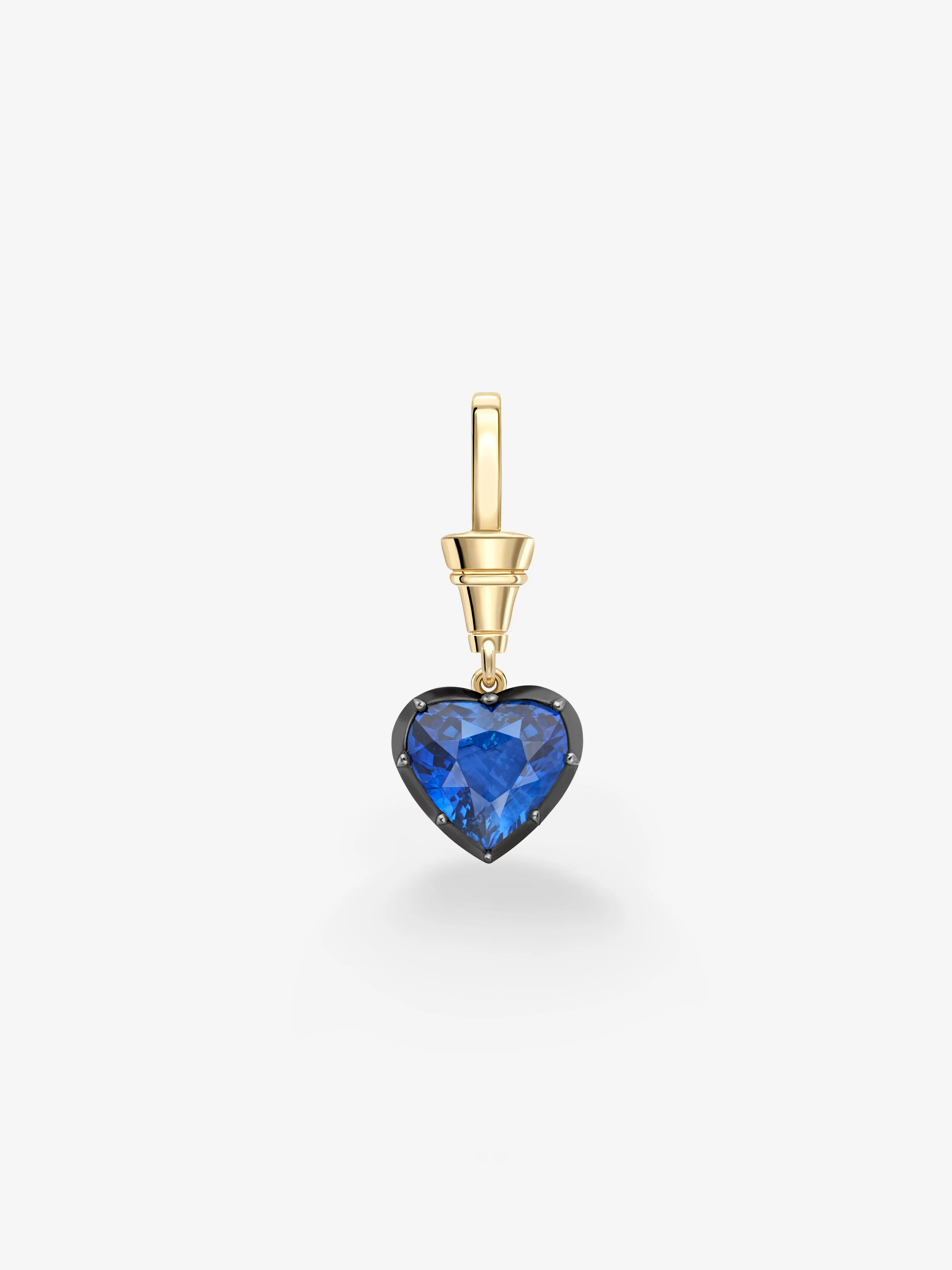 Heart-shaped blue sapphire pendant set in yellow gold with an antique-inspired blackened gold bezel, combining contemporary design with timeless craftsmanship. View 1