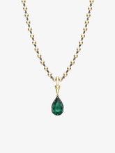 Pear-shaped emerald pendant set in yellow gold with a delicate gold ball chain, showcasing a contemporary design with antique-inspired craftsmanship.