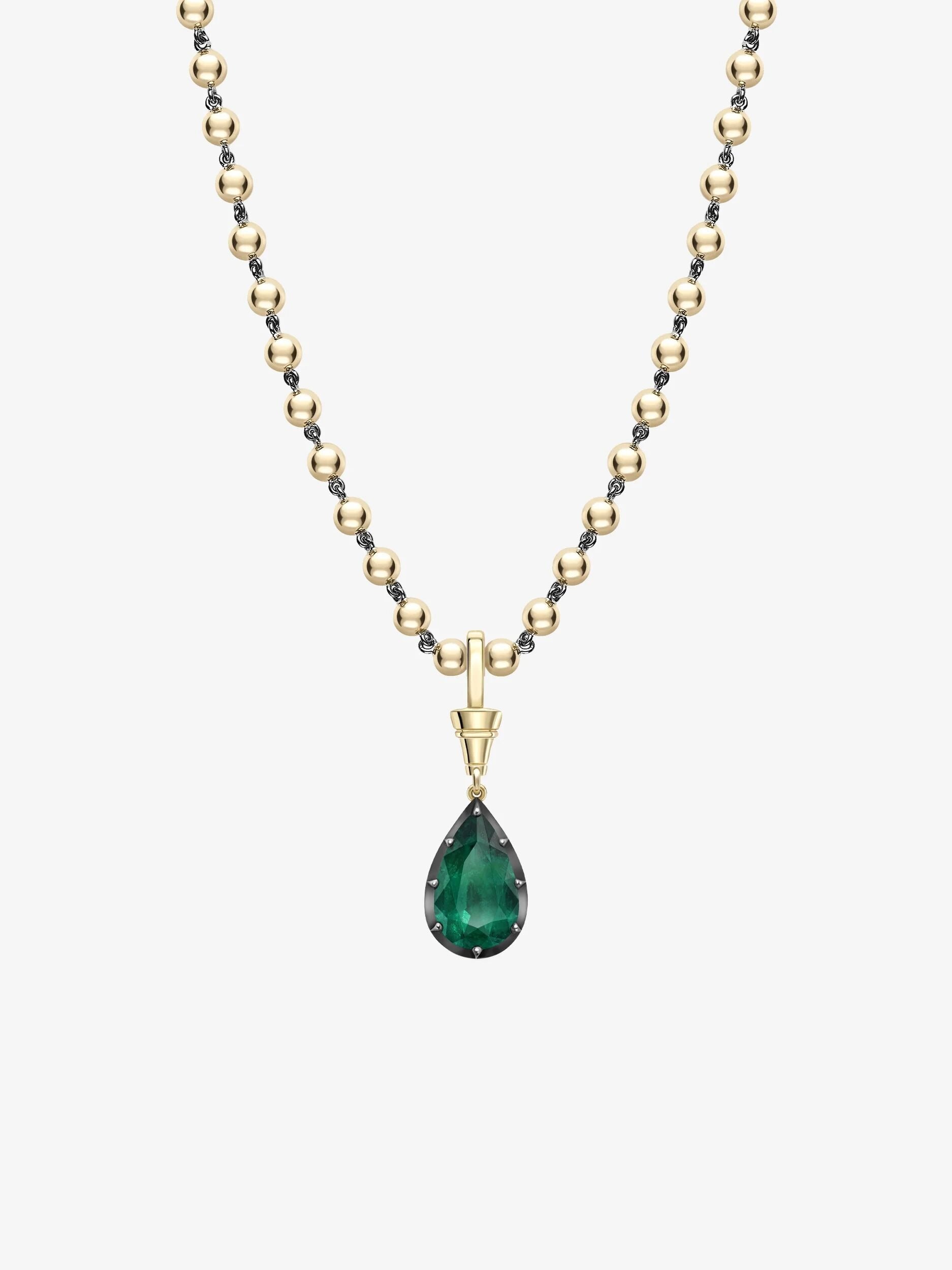 Pear-shaped emerald pendant set in yellow gold with a delicate gold ball chain, showcasing a contemporary design with antique-inspired craftsmanship. View 2