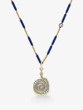 Necklace featuring a gold and blue beaded chain with a spiral medallion pendant set with a swirl of diamonds, blending antique-inspired and contemporary design.