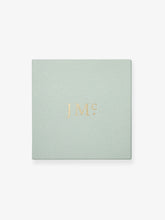 Soft green jewelry box with gold embossed JM logo, reflecting Jessica McCormack’s blend of antique inspiration and contemporary elegance.
