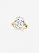 Oval diamond ring featuring a 9.33-carat stone set in a yellow gold band with an elegant, antique-inspired looping design.